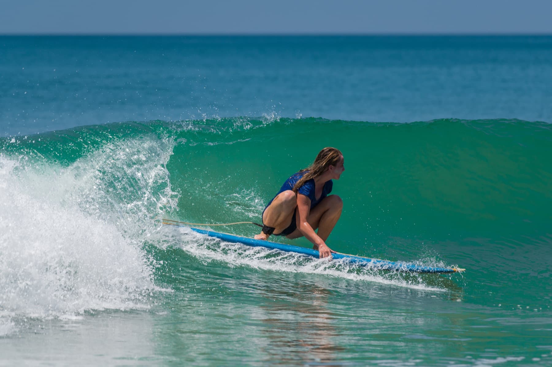 Surfer riding a longboard wave in Fuerteventura
